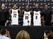 Portland Trail Blazers general manager Joe Cronin, left, and head coach Chauncey Billups, right, stand with draft pics, Rayan Rupert (72), Scoot Henderson (00), and Kris Murray (8) while they hold up their new jerseys during an NBA basketball news conference in Portland, Ore., Saturday, June 24, 2023.