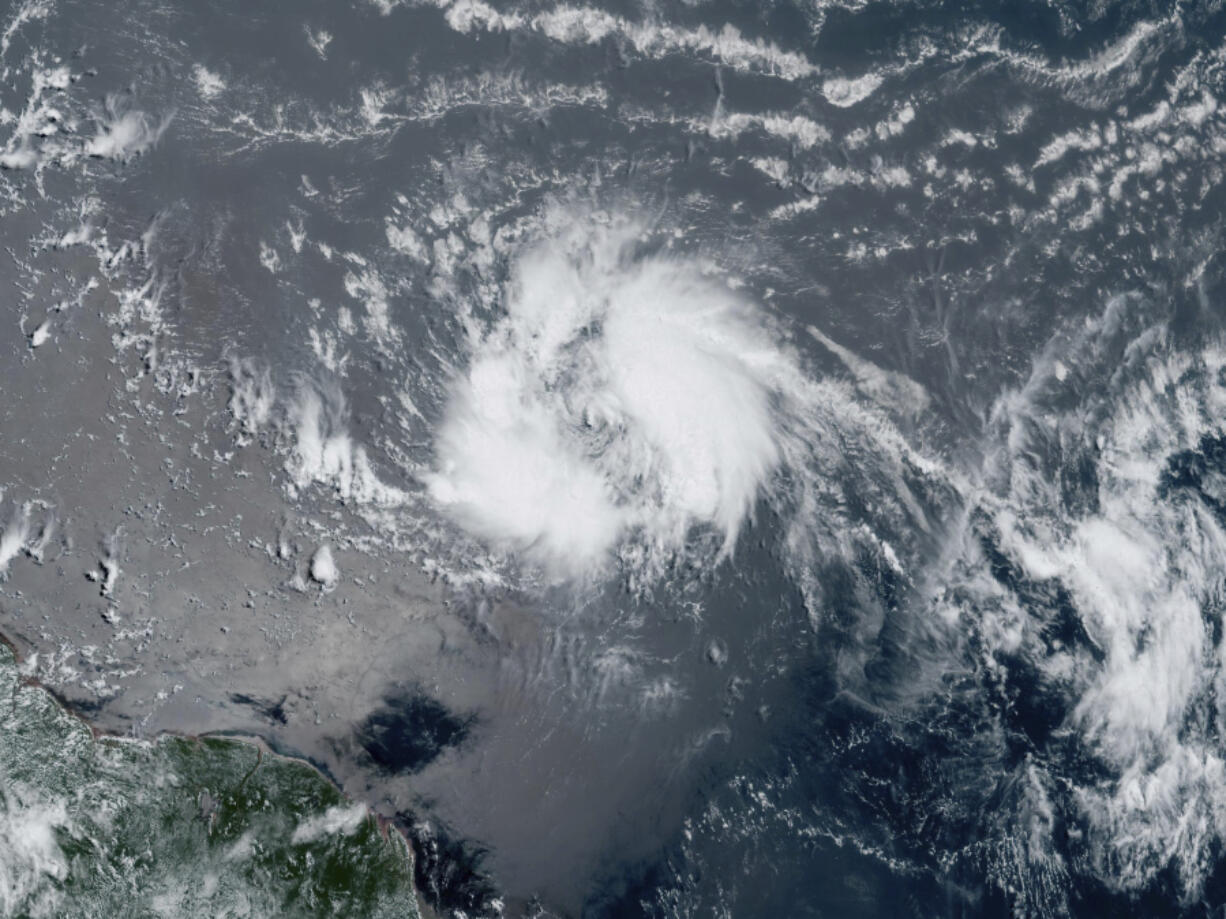 This GeoColor satellite image taken Tuesday, June 20, 2023 and provided by NOAA, shows Tropical Storm Bret as it chugged toward the eastern Caribbean.