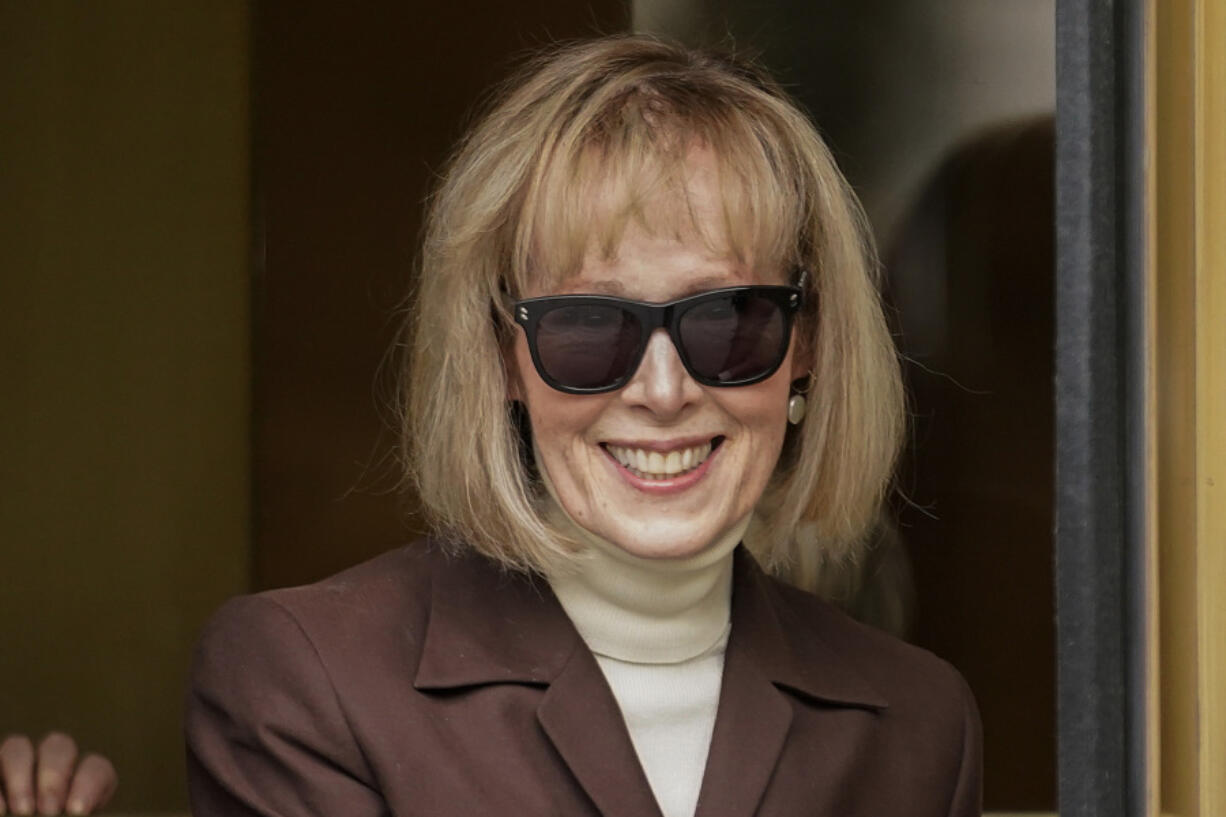 E. Jean Carroll, center, walks out of Manhattan federal court, Tuesday, May 9, 2023, in New York. In a written submission Thursday, June 8, 2023, lawyers for Donald Trump say a $5 million jury award for his sexual abuse and defamation of columnist E. Jean Carroll in a department store dressing room, in 1996, should be slashed to less than $1 million.