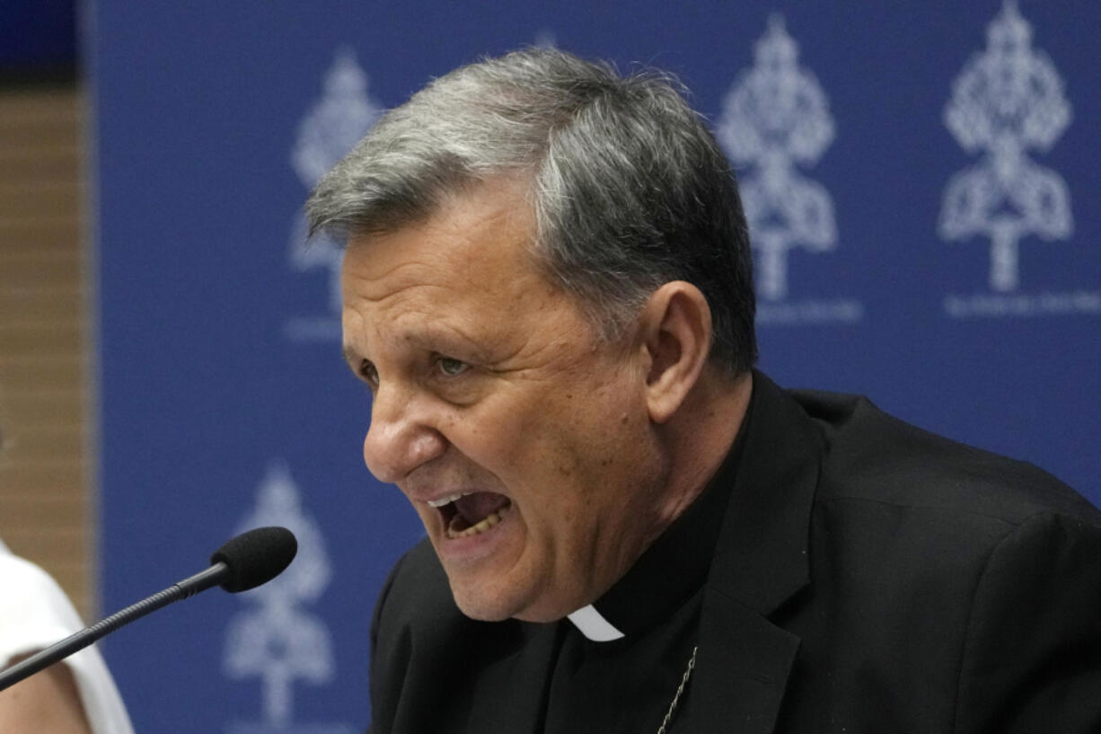 Secretary General of the Synod of Bishops Cardinal Mario Grech, right, delivers his speech during a presentation of the new guidelines for the Synod of Bishops at the Vatican, Tuesday, June 20, 2023.