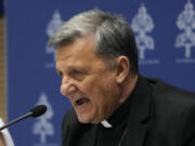 Secretary General of the Synod of Bishops Cardinal Mario Grech, right, delivers his speech during a presentation of the new guidelines for the Synod of Bishops at the Vatican, Tuesday, June 20, 2023.