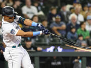 Seattle Mariners' Julio Rodriguez breaks his bat as he flies out against the Chicago White Sox during the first inning of a baseball game, Sunday, June 18, 2023, in Seattle.