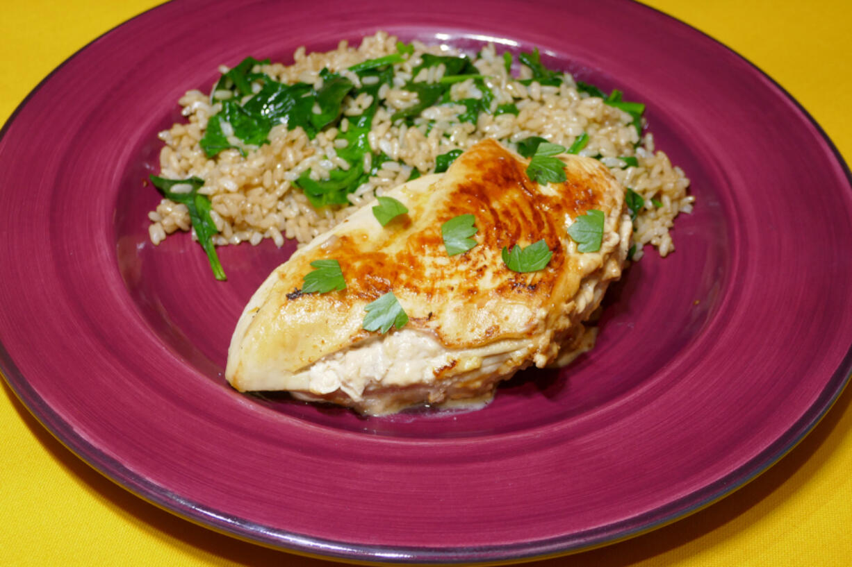 Caramelized Onion-Stuffed Chicken Breast with Spinach and Brown Rice.