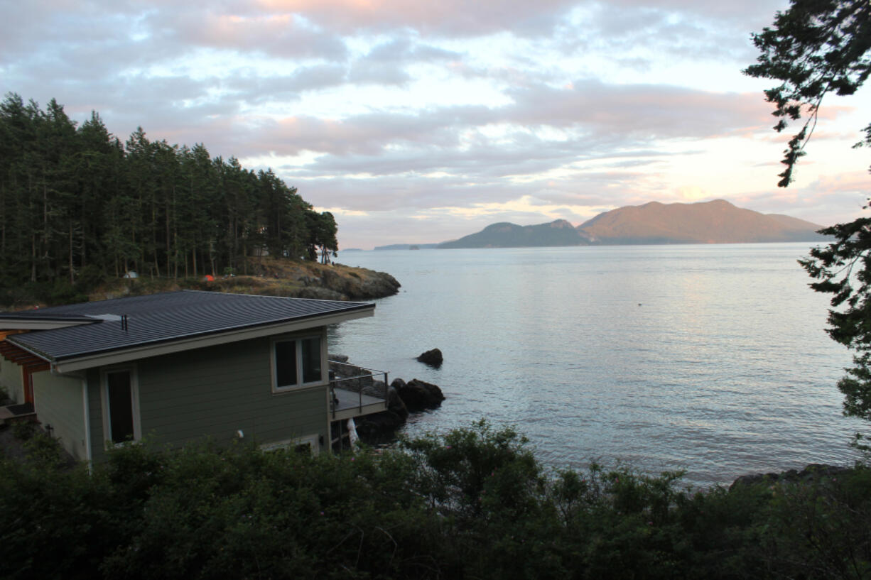 Evening sun illuminates Cypress Island across Rosario Strait from Doe Bay Resort and Retreat on Orcas Island, which commands one of the best views in the San Juans.