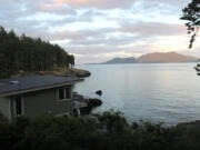 Evening sun illuminates Cypress Island across Rosario Strait from Doe Bay Resort and Retreat on Orcas Island, which commands one of the best views in the San Juans.