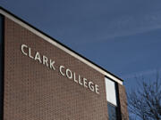 Morning sun illuminates a sign on a building at Clark College in January 2022.