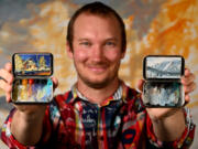 Painter Remington Robinson shows off two of his painted Altoids tin boxes at his art studio in Boulder, Colo. (Helen H.