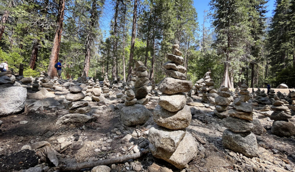 A field of cairns along the lower Yosemite Falls trail on July 9, 2023, in Yosemite Valley. The park said rock cairn building should be left to rangers and trail workers.