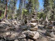 A field of cairns along the lower Yosemite Falls trail on July 9, 2023, in Yosemite Valley. The park said rock cairn building should be left to rangers and trail workers.