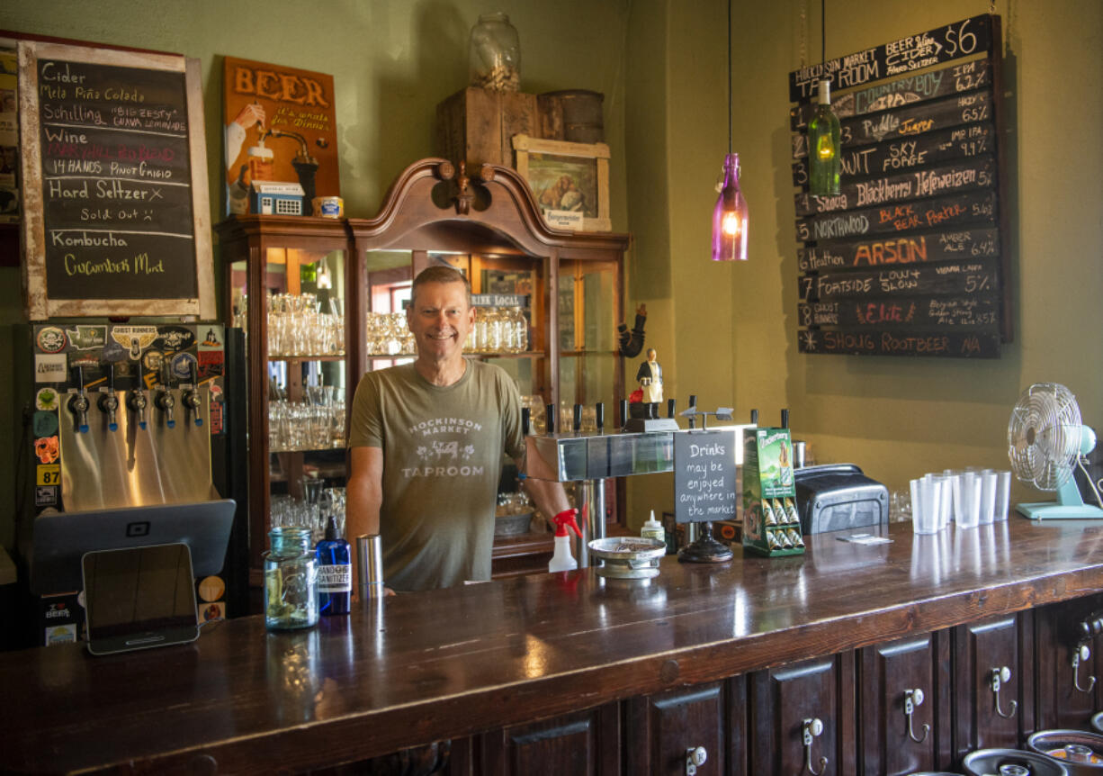 Hockinson Market owner Jim Van Natta stands behind the taproom bar, located in the space that used to house the area's post office.