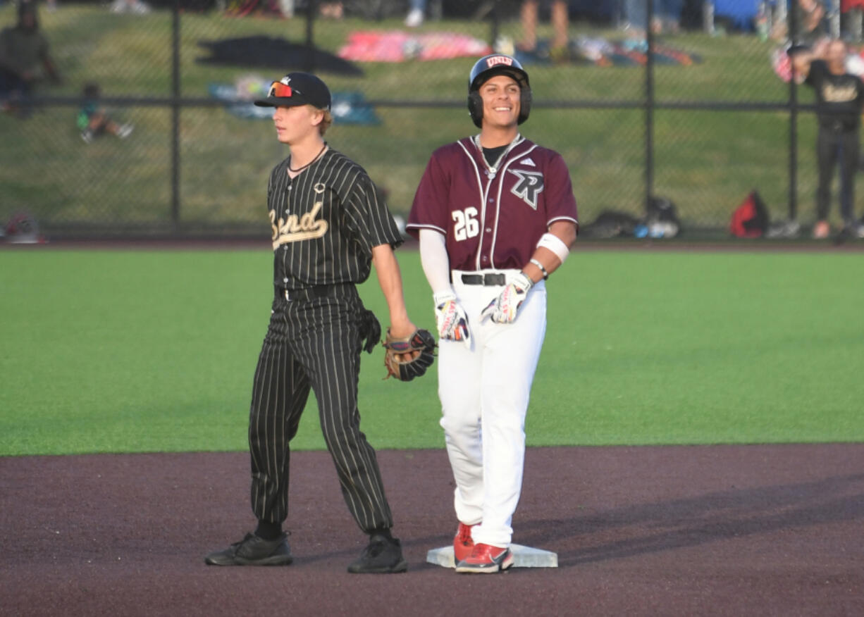Raptors player Jacob Sharp, right, smiles after hitting a RBI double Tuesday, June 27, 2023, during the Raptors??? game against Bend at the Ridgefield Outdoor Recreation Complex.
