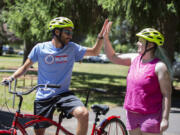 Programs specialist Matt Coelho, left, gives camper Audrey Walter, 18, a high five at Camp Spark in Sandy, Ore., on June 30, 2023. Camp Spark is a weeklong outdoor recreation camp tailored to youth aged 8 to 21 with visual impairments. This session in particular hosted campers who, in addition to visual impairments, have an additional intellectual disability.