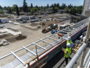 PeaceHealth director of planning, design and construction Rick Sanders, right, and senior director of marketing and communications Debra Carnes stand atop the roof of the new emergency department expansion.