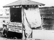 In 1912, a man sold stamps for the first airmail service between Portland and Vancouver. Walter Edwards made this first interstate flight carrying 5,000 uniquely postmarked letters, some with stamps sold from this booth. Official airmail stamps weren't sold until 1918.