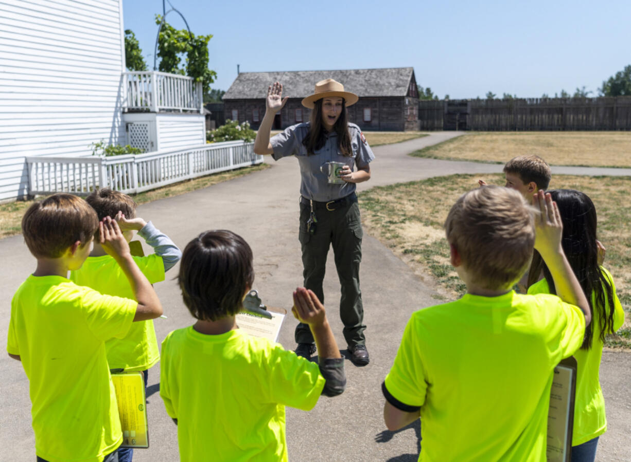 Park guide Sarah Weber has a group of Bike Clark County campers take the junior ranger oath Tuesday at Fort Vancouver National Historic Site.