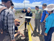 During a portion of their program in Hawaii, participants learn how to assemble GPS stations with Logan Fusso, U.S. Geological Survey deformation technician, to monitor ground deformation on volcanoes and examine the data in real-time.