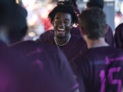 Raptors player Reiss Calvin smiles in the dugout after scoring a run Friday, July 14, 2023, during the Raptors’ game against Yakima Valley at the Ridgefield Outdoor Recreation Complex.