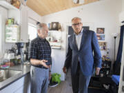 James Walls, left, a Vietnam Veteran and resident of Fruit Valley Terrace, welcomes Gov. Jay Inslee to his home during a tour of the property.