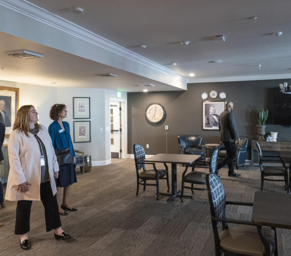 Employment Security Department Commissioner Cami Feek, left, and Workforce Southwest Washington Director of Communications Julia Maglione, right, look around a room during a Workforce Southwest Washington tour of The Inn at University Village assisted living facility.