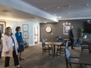 Employment Security Department Commissioner Cami Feek, left, and Workforce Southwest Washington Director of Communications Julia Maglione, right, look around a room during a Workforce Southwest Washington tour of The Inn at University Village assisted living facility.