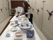 Meagan Huff, museum curator at Fort Vancouver National Historic Site, examines the artifacts that will be included in the upcoming exhibition.