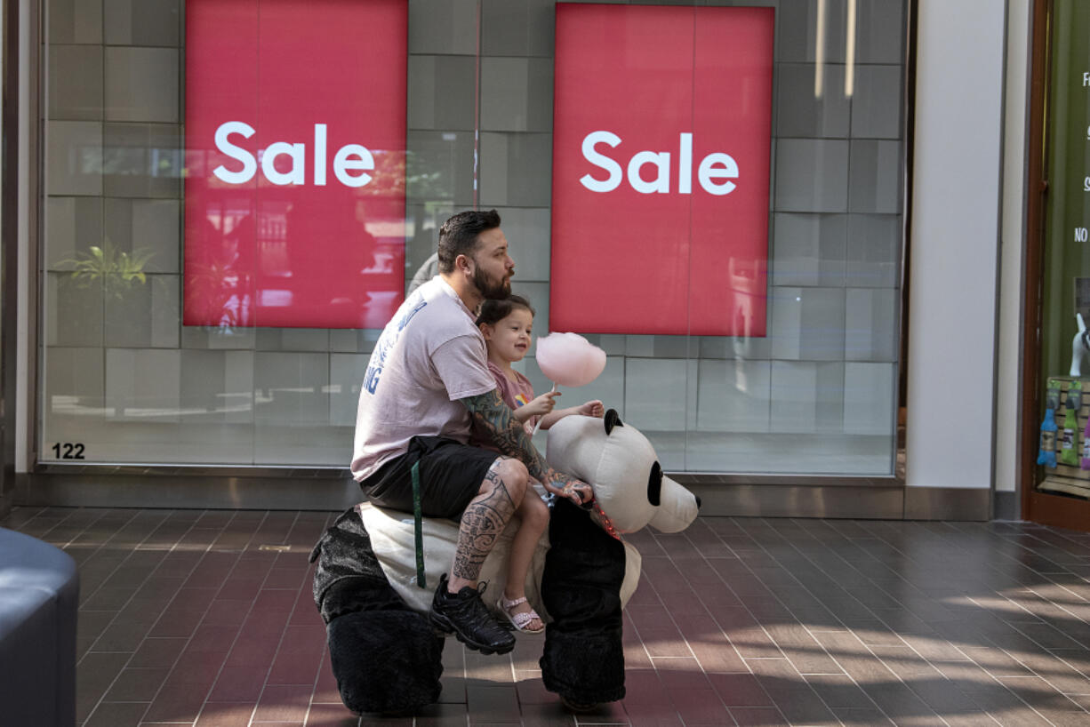 Chris Miranda of Vancouver and his daughter, Gabriella, 5, catch a ride on an oversized stuffed mobile panda at Vancouver Mall on Friday afternoon. The pair were at the mall to get some ideas for clothes before Gabriella starts her first day of kindergarten. "It's a big one ... she's a ball of excitement," Chris Miranda said.