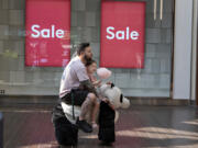 Chris Miranda of Vancouver and his daughter, Gabriella, 5, catch a ride on an oversized stuffed mobile panda at Vancouver Mall on Friday afternoon. The pair were at the mall to get some ideas for clothes before Gabriella starts her first day of kindergarten. "It's a big one ... she's a ball of excitement," Chris Miranda said.