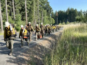 The Warm Springs Interagency Hotshot Crew moves between divisions on Friday while battling the Tunnel Five Fire in the Columbia River Gorge.