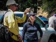 Washington State Lands Commissioner Hilary Franz talks with wildland firefighters battling the Tunnel Five Fire in the Columbia River Gorge on Thursday.