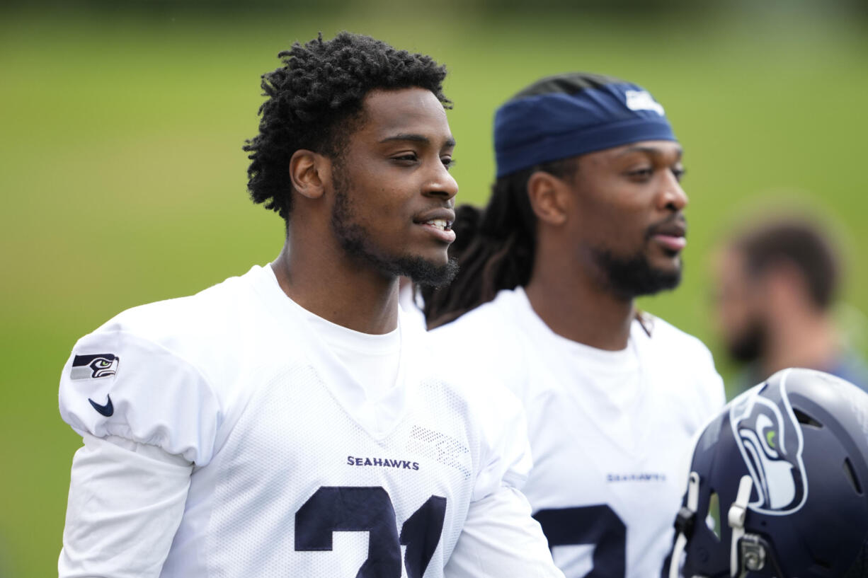 Seattle Seahawks cornerback Devon Witherspoon (21) walks onto the field Monday, May 22, 2023, at the team's NFL football training facility in Renton, Wash.