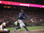 Seattle Mariners' Julio Rodriguez hits a double RBI against San Francisco Giants catcher Blake Sabol (2) in the ninth inning of a baseball game in San Francisco, Monday, July 3, 2023.