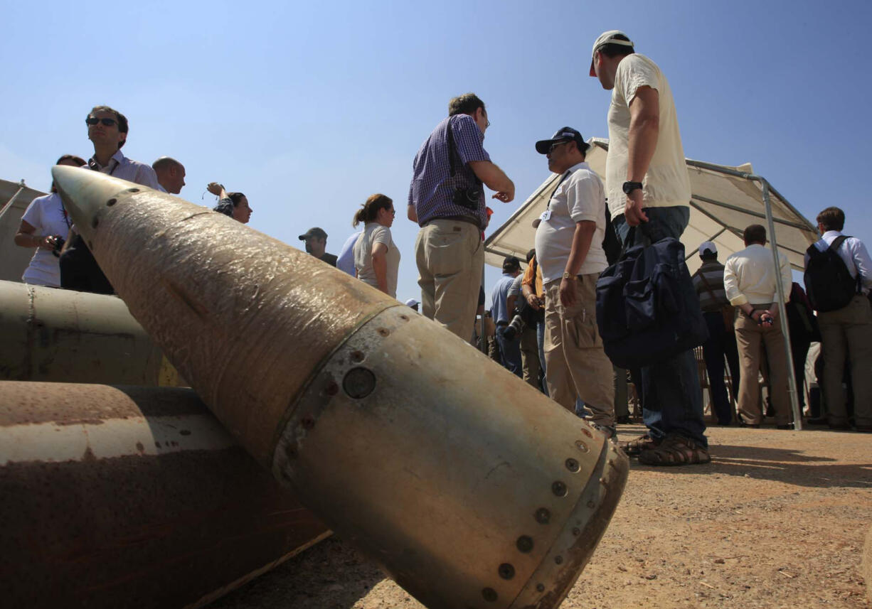 FILE - Activists and international delegations stand next to cluster bomb units, during a visit to a Lebanese military base at the opening of the Second Meeting of States Parties to the Convention on Cluster Munitions, in the southern town of Nabatiyeh, Lebanon, Sept. 12, 2011. The Biden administration has decided to provide cluster munitions to Ukraine and is expected to announce on Friday, July 6, 2023, that the Pentagon will send thousands as part of the latest military aid package for the war effort against Russia, according to people familiar with the decision.