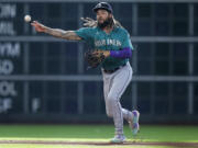 Seattle Mariners shortstop J.P. Crawford throws out Houston Astros' Mauricio Dubon at first during the first inning of a baseball game Saturday, July 8, 2023, in Houston. (AP Photo/Kevin M.