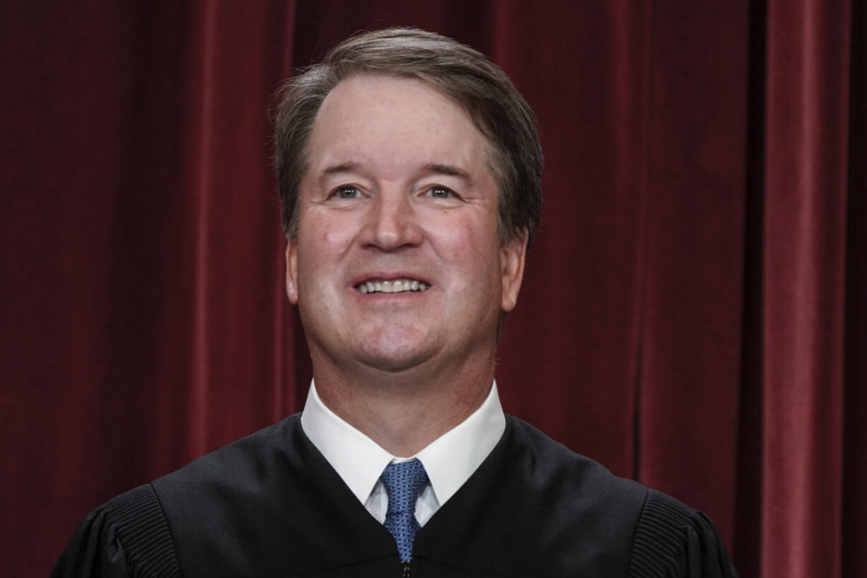 FILE - Supreme Court Justice Brett Kavanaugh poses for a new group portrait at the Supreme Court building in Washington, Oct. 7, 2022. Teaching is encouraged as a way to demystify the Supreme Court while exposing the justices to a cross-section of the public. Yet documents obtained by The Associated Press through public records requests reveal that some all-expense paid trips, particularly to attractive locales stateside and abroad, are light on classroom instruction, with ample time carved out for the justices' leisure. (AP Photo/J.