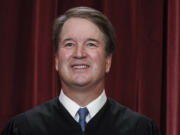 FILE - Supreme Court Justice Brett Kavanaugh poses for a new group portrait at the Supreme Court building in Washington, Oct. 7, 2022. Teaching is encouraged as a way to demystify the Supreme Court while exposing the justices to a cross-section of the public. Yet documents obtained by The Associated Press through public records requests reveal that some all-expense paid trips, particularly to attractive locales stateside and abroad, are light on classroom instruction, with ample time carved out for the justices' leisure. (AP Photo/J.