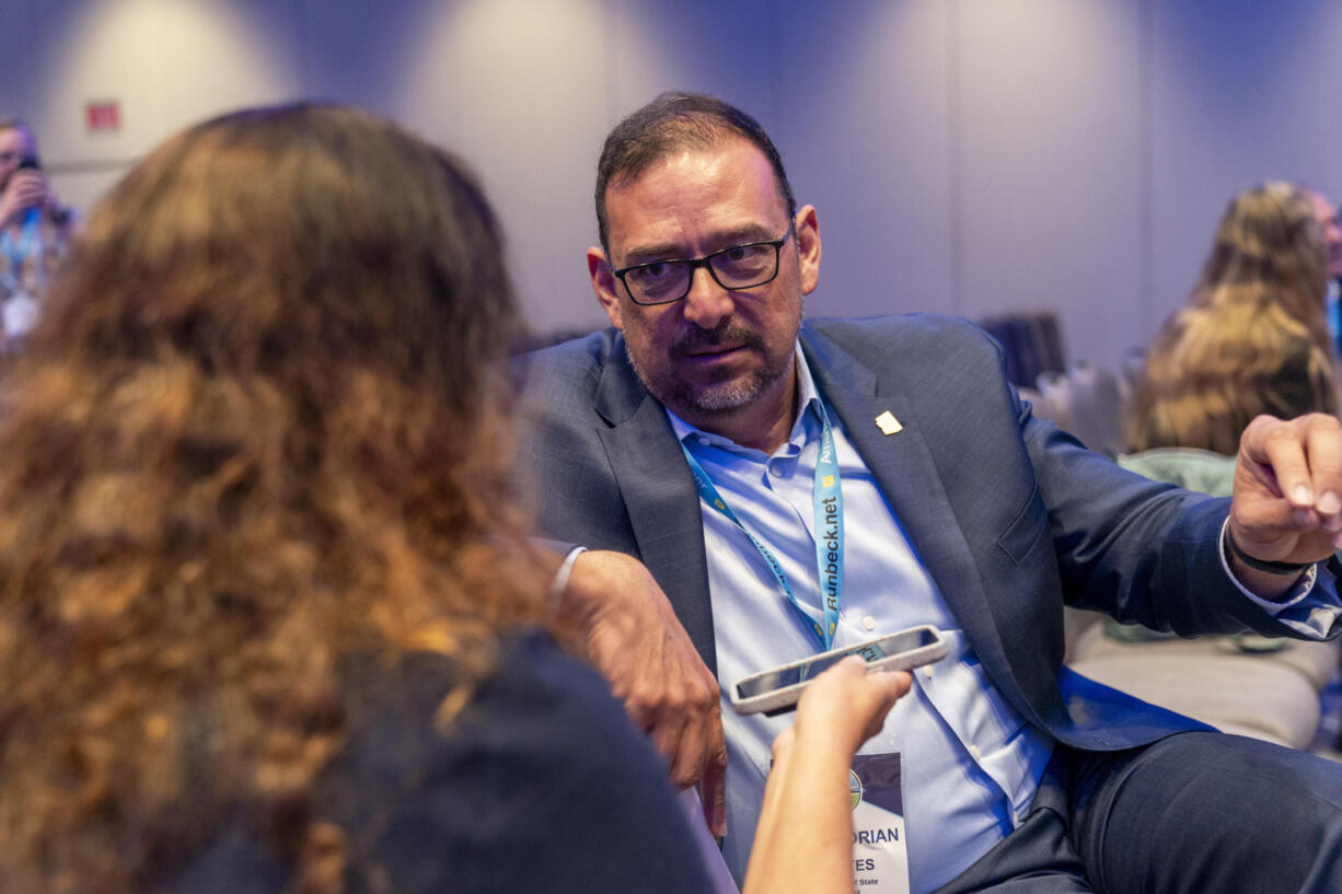 Arizona Secretary of State Adrian Fontes, right, attends the summer meeting of the National Association of Secretaries of State, Tuesday, July 11, 2023, in Washington. Efforts to deceive the public about voting and elections remain a top concern for state election officials as they dig into preparations for the 2024 election.