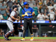 Seattle Mariners' Julio Rodriguez reacts to striking out looking to end the baseball game, next to Detroit Tigers catcher Jake Rogers on Friday, July 14, 2023, in Seattle. Detroit won 5-4.