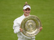 Czech Republic's Marketa Vondrousova celebrates with the trophy after beating Tunisia's Ons Jabeur to win the final of the women's singles on day thirteen of the Wimbledon tennis championships in London, Saturday, July 15, 2023.