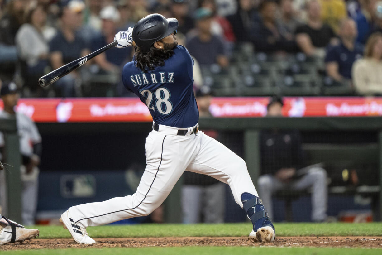 Seattle Mariners' Eugenio Suarez hits a two-run home run off Minnesota Twins relief pitcher Oliver Ortega during the seventh inning of a baseball game, Monday, July 17, 2023, in Seattle.