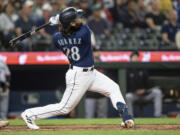 Seattle Mariners' Eugenio Suarez hits a two-run home run off Minnesota Twins relief pitcher Oliver Ortega during the seventh inning of a baseball game, Monday, July 17, 2023, in Seattle.