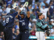 National League's Elias D?az, of the Colorado Rockies (35), celebrates his two run home run with Nick Castellanos (8), of the Philadelphia Phillies, in the eighth inning during the MLB All-Star Game in Seattle, Tuesday. That helped the National League win for the first time since 2012.