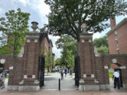 FILE - Students walk through a gate at Harvard University, Thursday, June 29, 2023, in Cambridge, Mass. In the wake of a Supreme Court decision that removes race from the admissions process, colleges are coming under renewed pressure to put an end to legacy preferences, the practice of favoring applicants with family ties to alumni. At Harvard, which released years of records as part of the lawsuit that ended up before the Supreme Court, legacy students were eight times more likely to be admitted, and nearly 70% were white, researchers found.