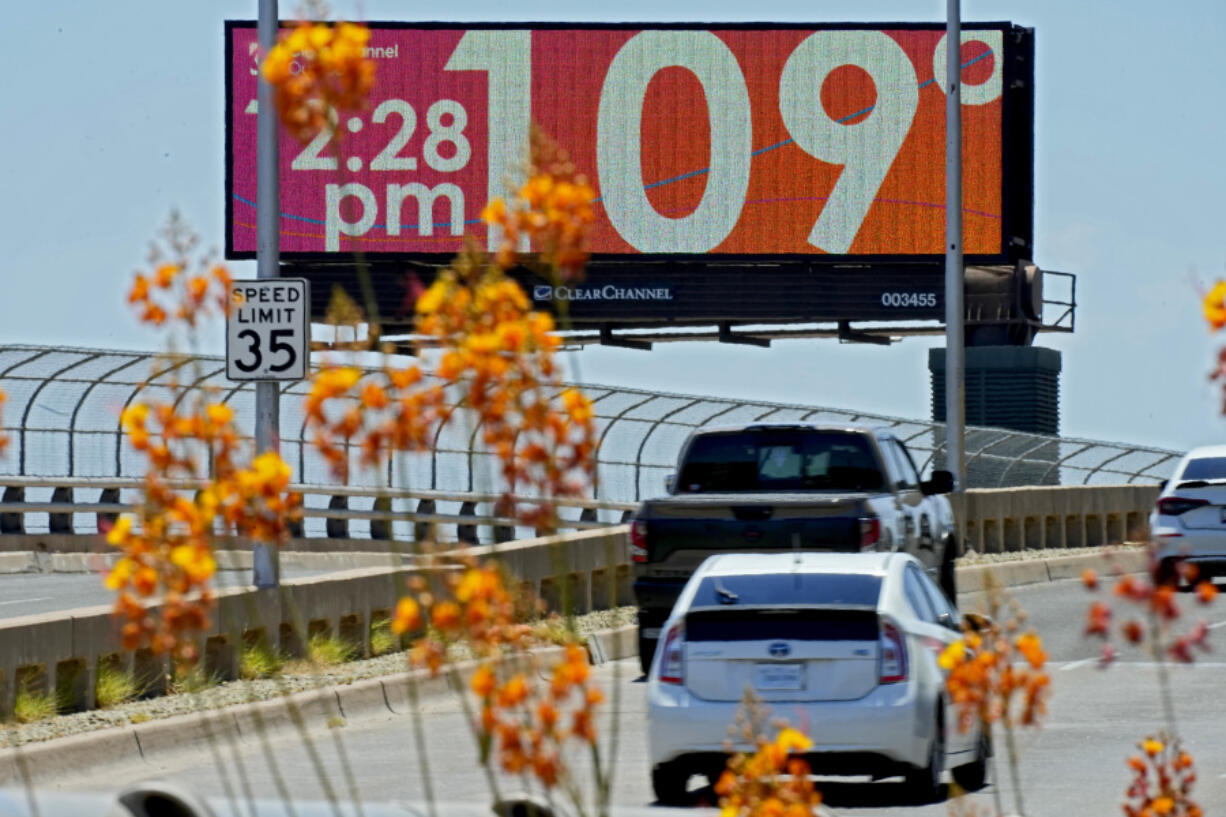 A digital billboard displays an unofficial temperature, Monday, July 17, 2023, in downtown Phoenix.