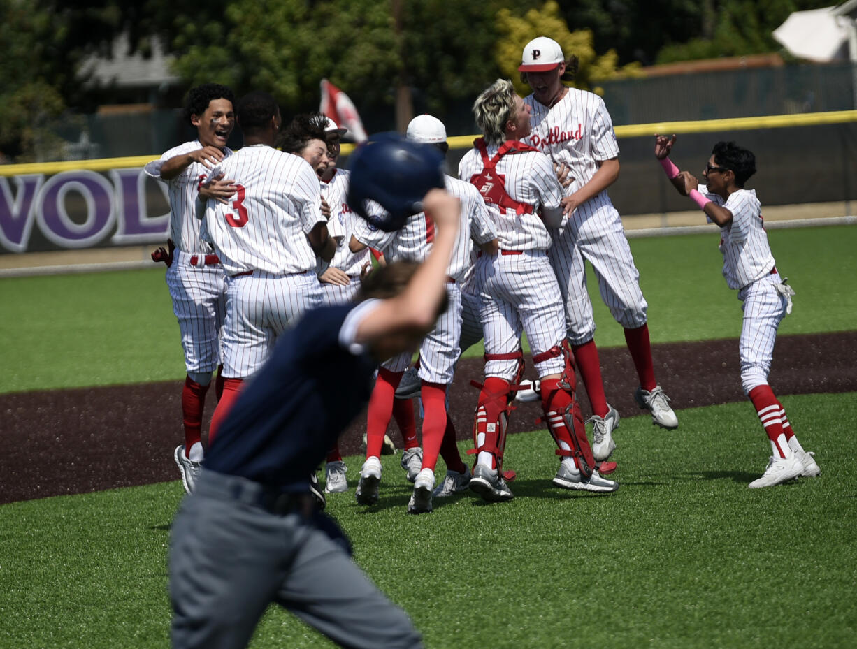 Dayton Mahoney (foreground) of Lookouts Sandlot from Centerfield Babe Ruth of Southwest Washington heads back to the dugout as Portland Babe Ruth celebrates its 8-7 win to capture the Pacific Northwest 13-15 Babe Ruth Regional title at Heritage High School on Thursday, July 27, 2023.