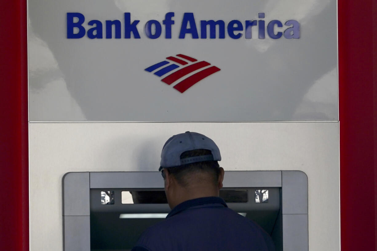 File - A customer uses an ATM at a Bank of America location in San Francisco, Monday, April 24, 2023. Bank of America is being ordered to pay more than $100 million to customers for double-dipping on some fees imposed on customers, withholding reward bonuses explicitly promised to credit card customers, and misappropriating sensitive personal information to open accounts without customer knowledge or authorization.