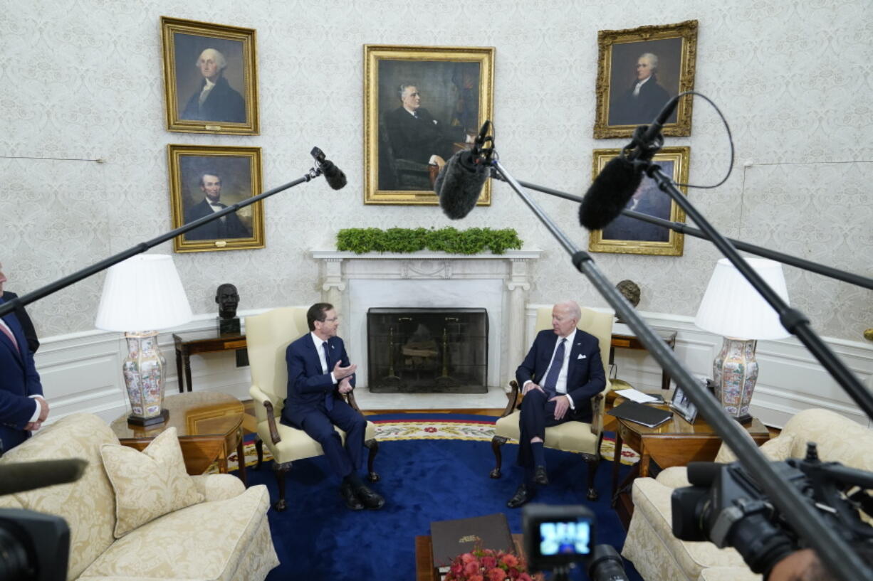 FILE - President Joe Biden and Israel's President Isaac Herzog talk during a meeting in the Oval Office of the White House, Oct. 26, 2022, in Washington.