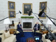 FILE - President Joe Biden and Israel's President Isaac Herzog talk during a meeting in the Oval Office of the White House, Oct. 26, 2022, in Washington.