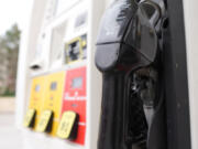 A handle sits at the ready on a gasoline pump at a Shell stastion Wednesday, July 5, 2023, in Englewood, Colo.