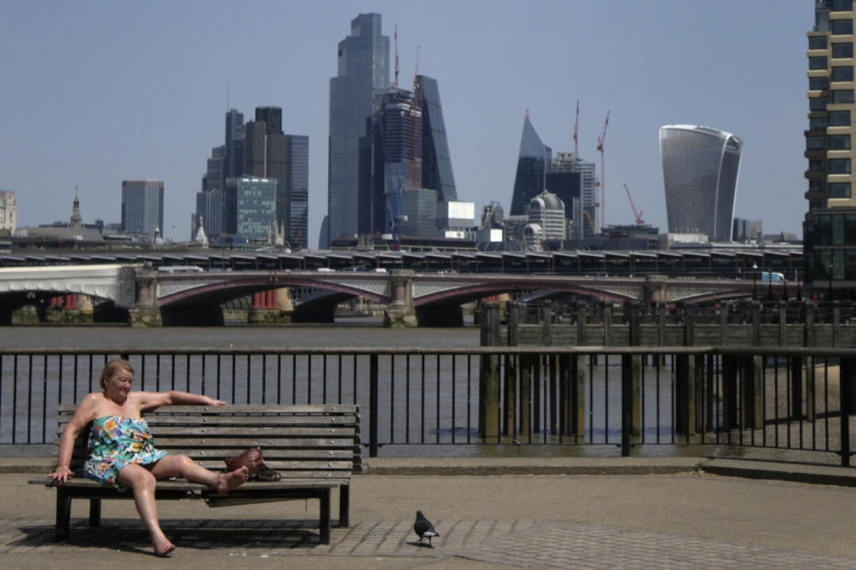 FILE - A woman sunbathes near the River Thames in front of a view of the City of London, on June 17, 2022. The U.K. sweltered through its hottest June since records began in 1884, the country's weather agency said Monday, July 3, 2023, adding that human-induced climate change means such unusual heat will become more frequent in the next few decades. The average temperature for June in the U.K. hit 15.8 degrees Celcius (   Fahrenheit) -- 0.9C hotter than the joint previous record of 14.9C in 1940 and 1976, according to the Met Office's provisional figures.