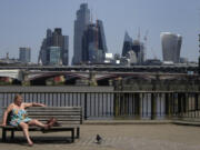 FILE - A woman sunbathes near the River Thames in front of a view of the City of London, on June 17, 2022. The U.K. sweltered through its hottest June since records began in 1884, the country's weather agency said Monday, July 3, 2023, adding that human-induced climate change means such unusual heat will become more frequent in the next few decades. The average temperature for June in the U.K. hit 15.8 degrees Celcius (   Fahrenheit) -- 0.9C hotter than the joint previous record of 14.9C in 1940 and 1976, according to the Met Office's provisional figures.